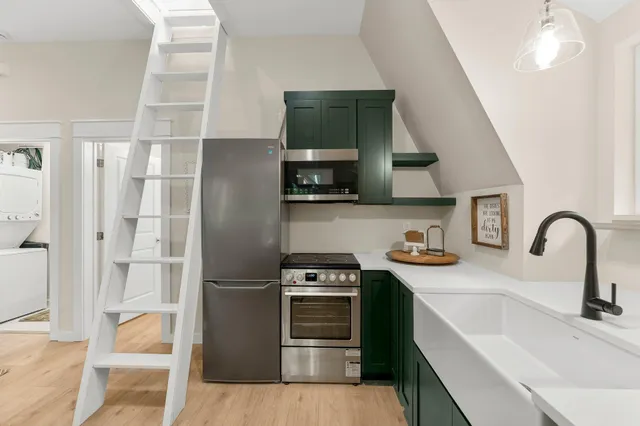 a kitchen with stainless steel appliances granite countertop a refrigerator and a sink