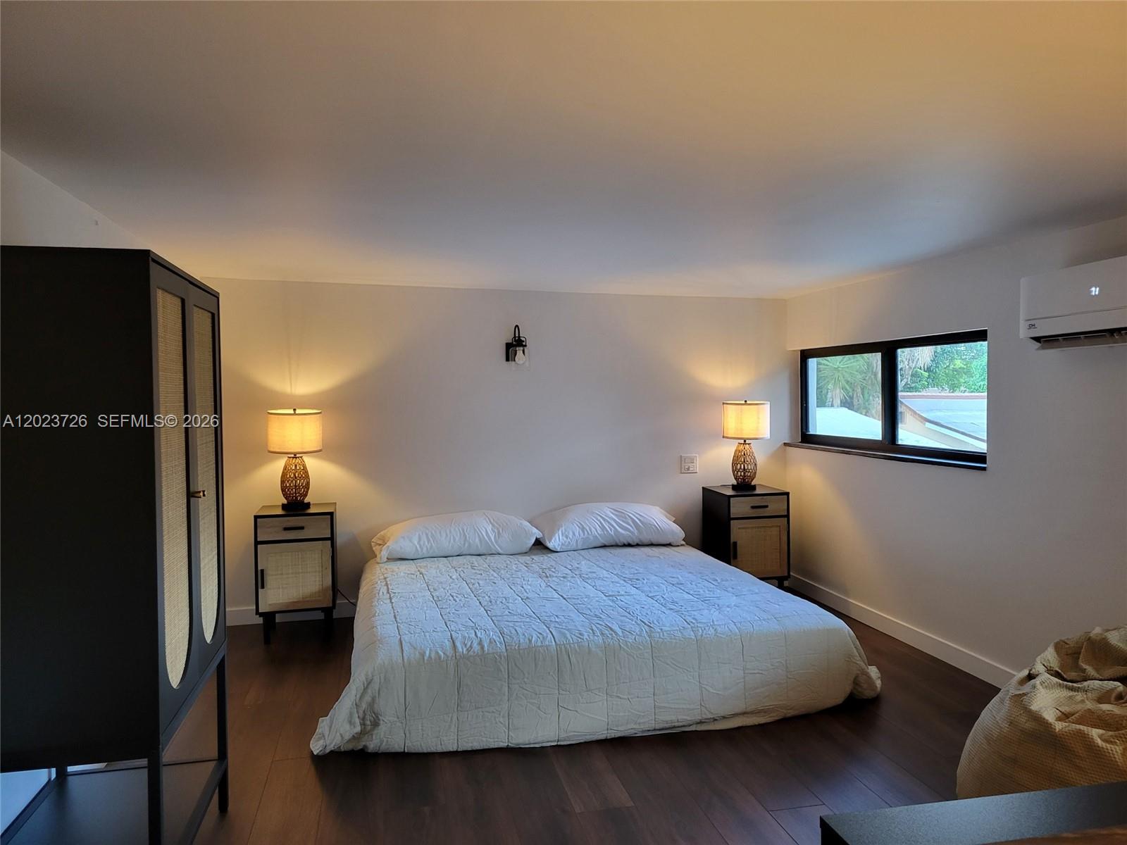 5866 Southwest 60th Street, Unit 3 Miami, FL 33143 - Photo 2 of 8 a bedroom with a bed and window