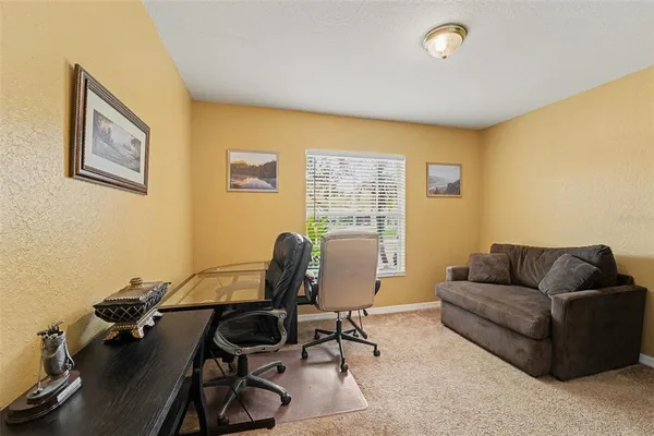 a view of a livingroom with workspace and a couch