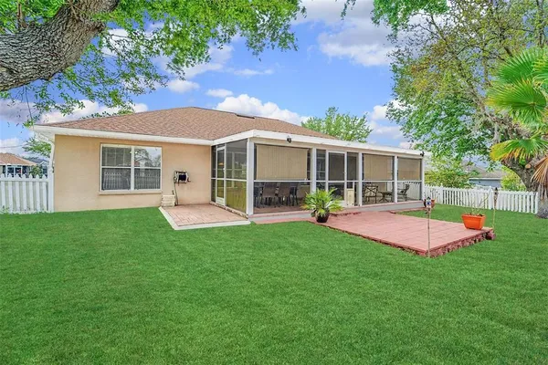 a view of a house with a yard and a patio
