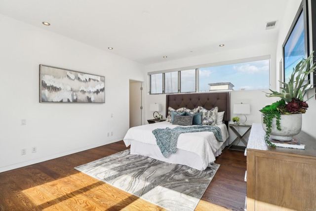 a bedroom with a large bed and a couch