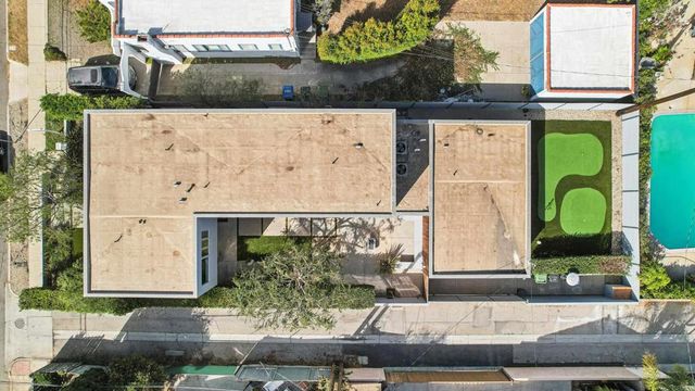 an aerial view of residential houses with city view