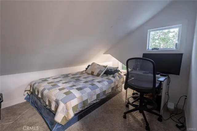 a bed room with a bed and a television