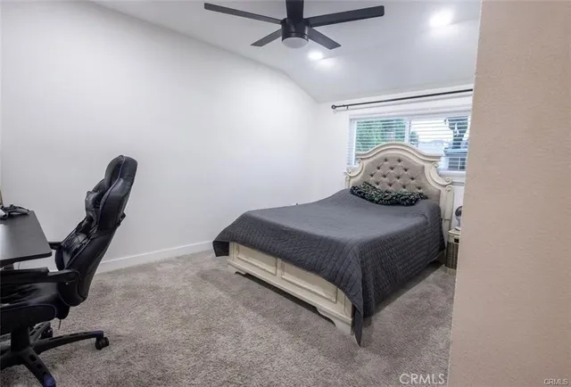 a view of a hallway with wooden floor and a kitchen