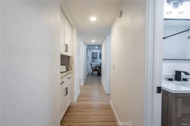a bathroom with a granite countertop sink mirror vanity and bathtub