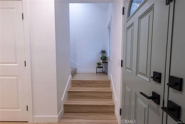 a view of an entryway with wooden floor