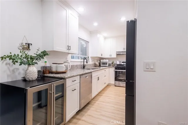 a kitchen with stainless steel appliances kitchen island granite countertop a sink and cabinets