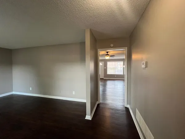 wooden floor fireplace and windows in an empty room
