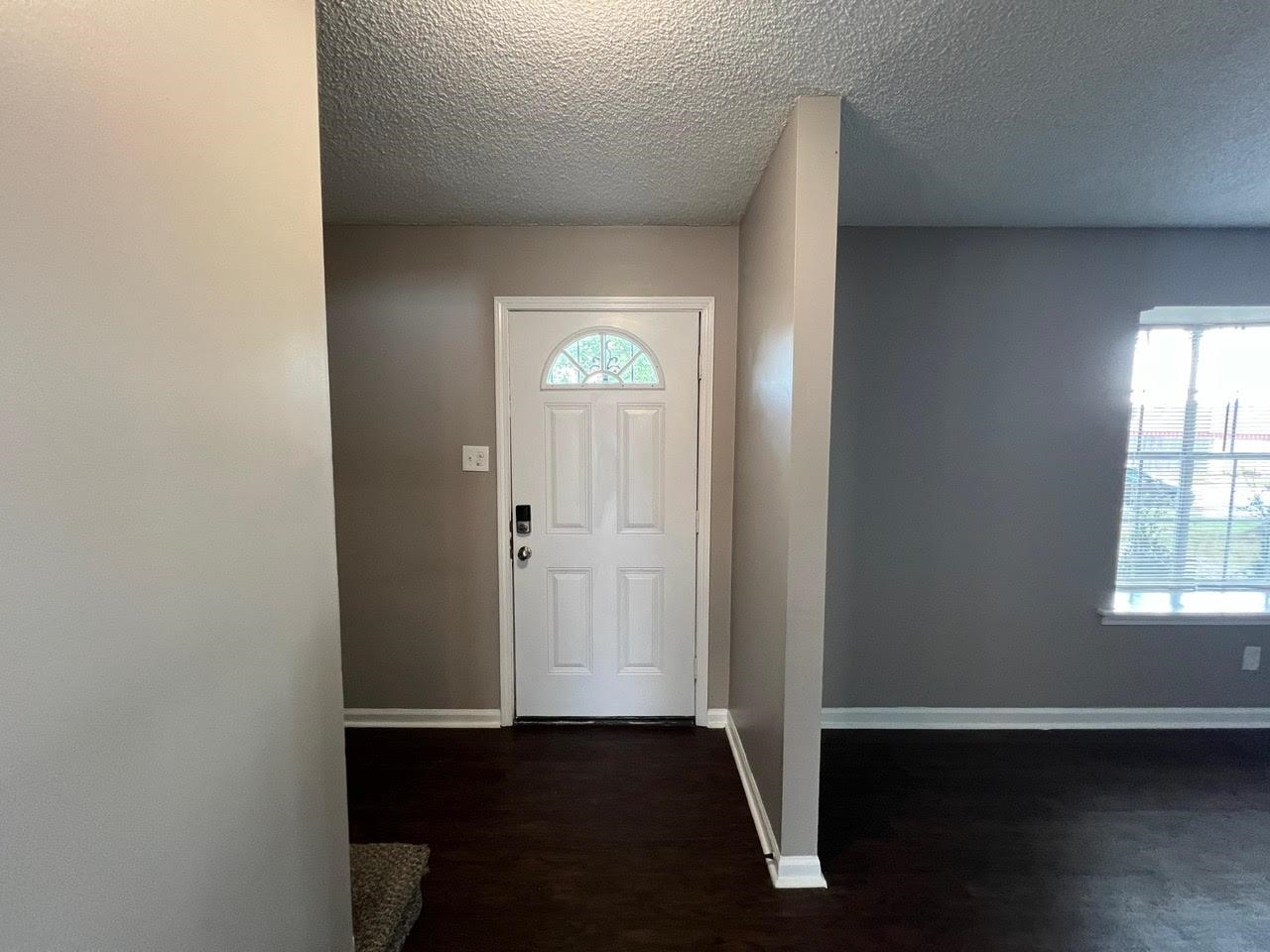 5995 Lofty Oak Road, Unit 5995 Memphis, TN 38115 - Photo 4 of 20 Entryway with a textured ceiling and dark hardwood / wood-style floors