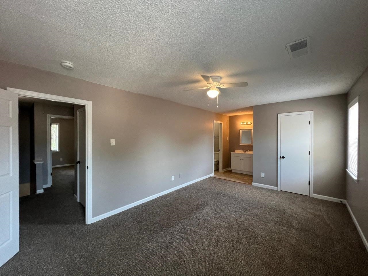 5995 Lofty Oak Road, Unit 5995 Memphis, TN 38115 - Photo 7 of 20 Unfurnished bedroom with ensuite bath, a textured ceiling, ceiling fan, and carpet flooring