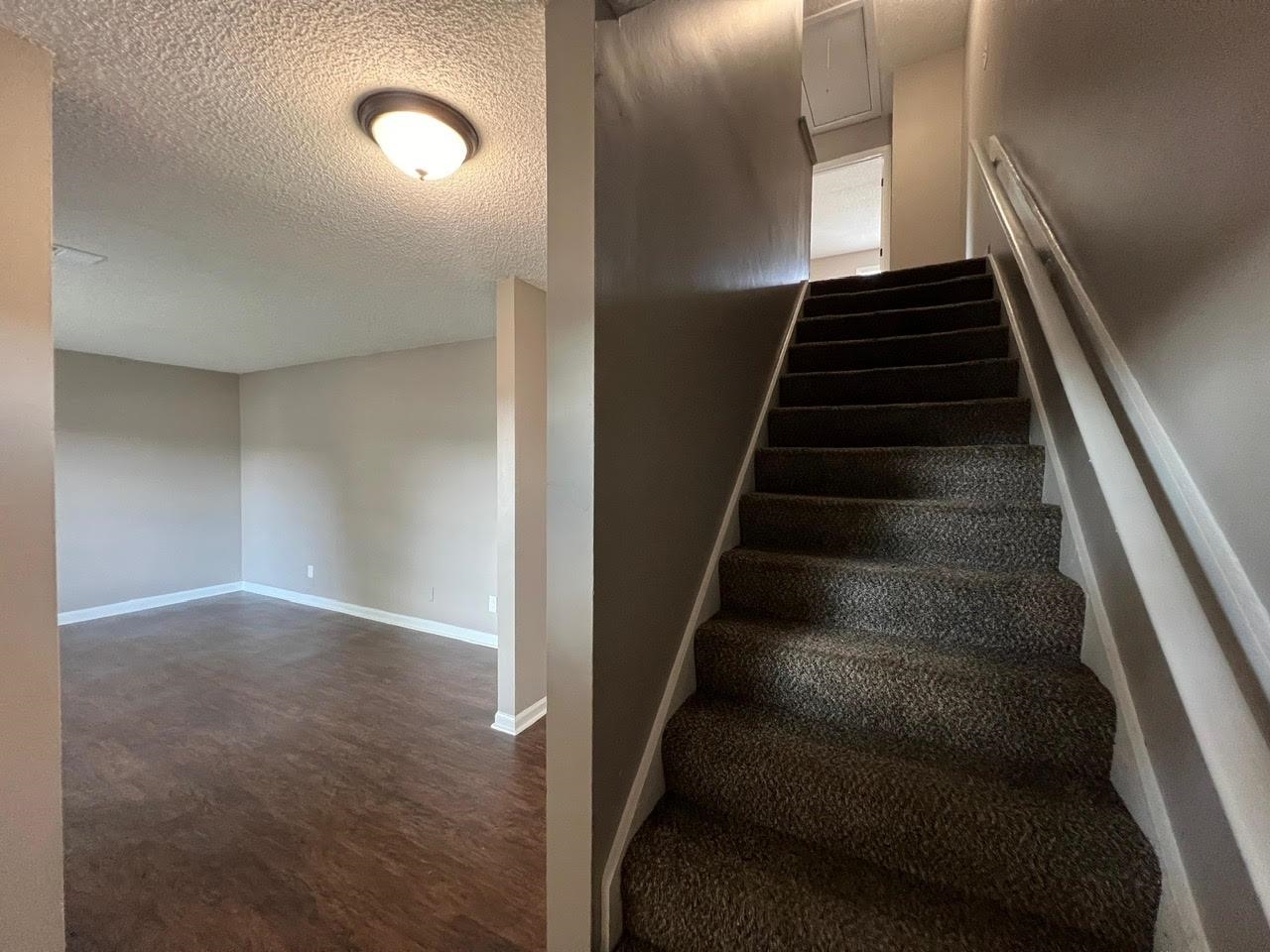 5995 Lofty Oak Road, Unit 5995 Memphis, TN 38115 - Photo 8 of 20 Stairway featuring a textured ceiling and hardwood / wood-style floors