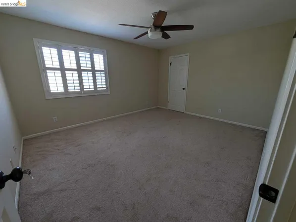 a view of room with a ceiling fan and window