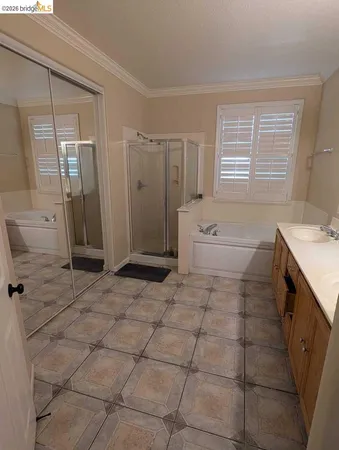 a spacious bathroom with a granite countertop sink a toilet and a bathtub
