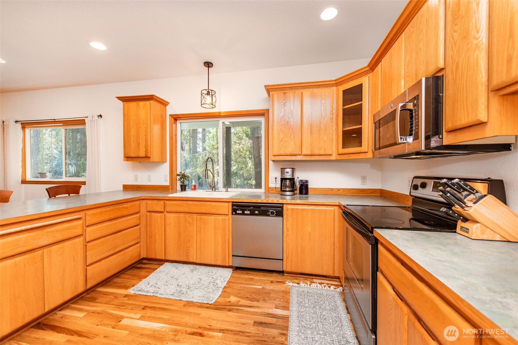 31 Josephine Place Sequim, WA 98382 - Photo 15 of 40 a kitchen with stainless steel appliances granite countertop a sink and cabinets
