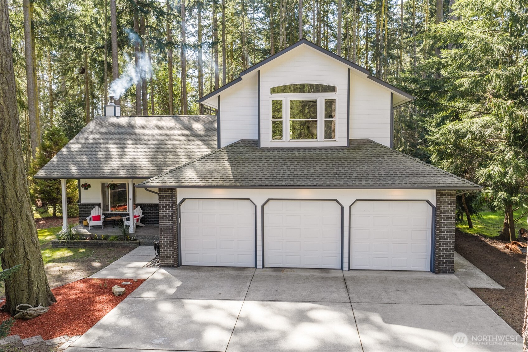 31 Josephine Place Sequim, WA 98382 - Photo 2 of 40 a front view of a house with a yard and garage
