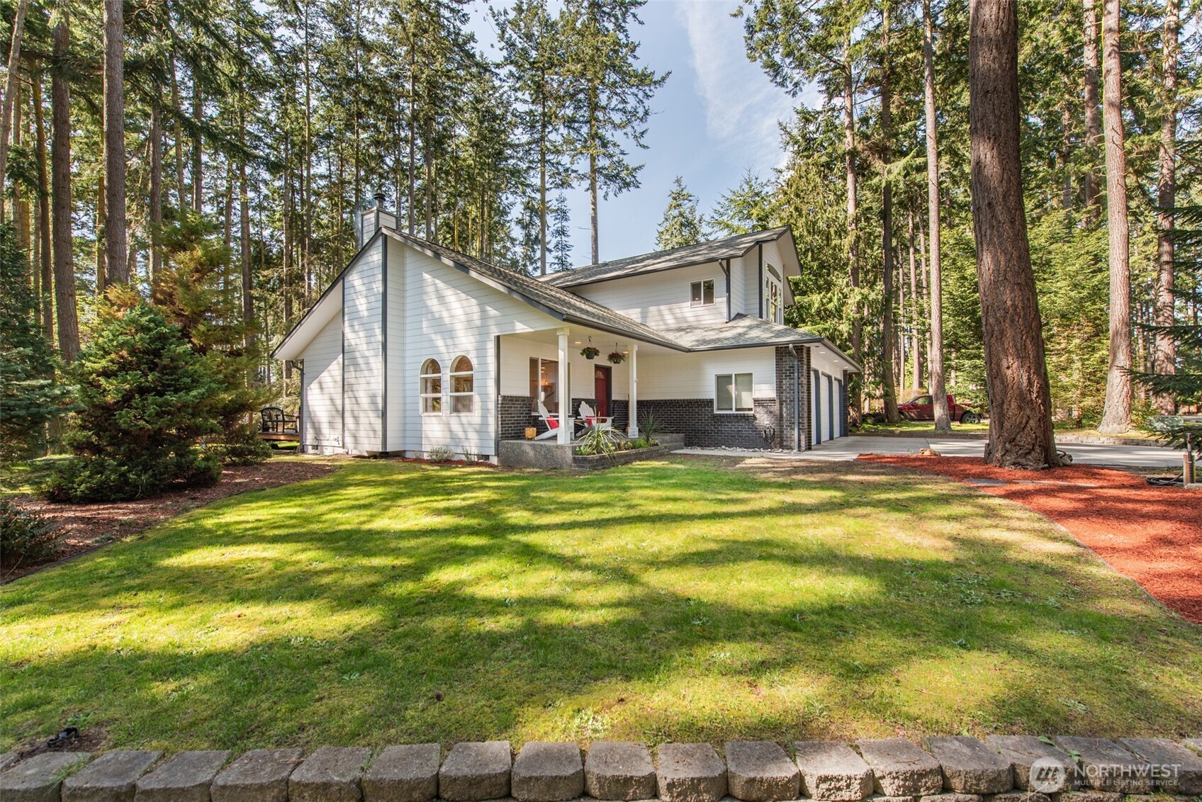 31 Josephine Place Sequim, WA 98382 - Photo 35 of 40 a front view of a house with a garden and trees