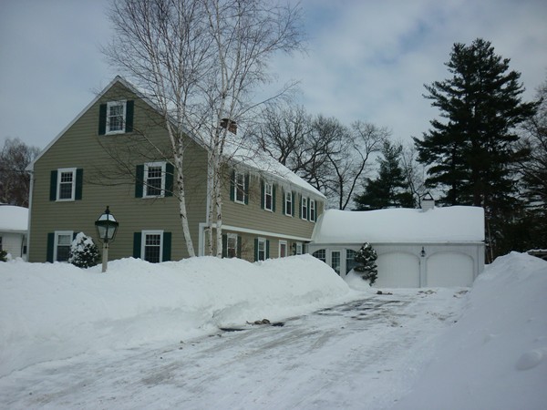 a view of a house with a snow in the yard