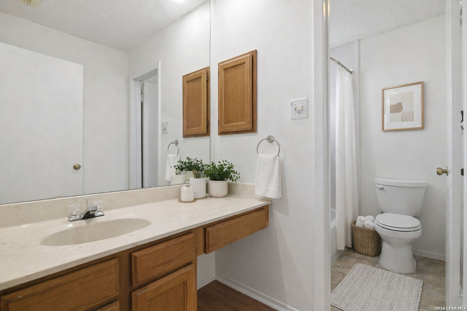 8702 Stream Circle San Antonio, TX 78250 - Photo 14 of 18 a bathroom with a sink and a mirror