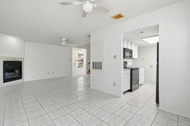 a view of a kitchen with a refrigerator and a stove top oven