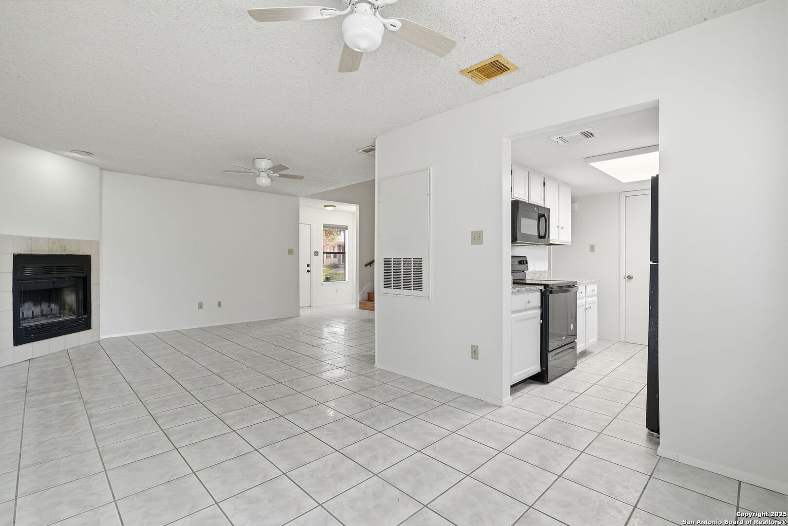8702 Stream Circle San Antonio, TX 78250 - Photo 2 of 18 a view of a kitchen with a refrigerator and a stove top oven