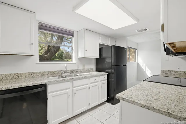 a kitchen with a sink stove and refrigerator