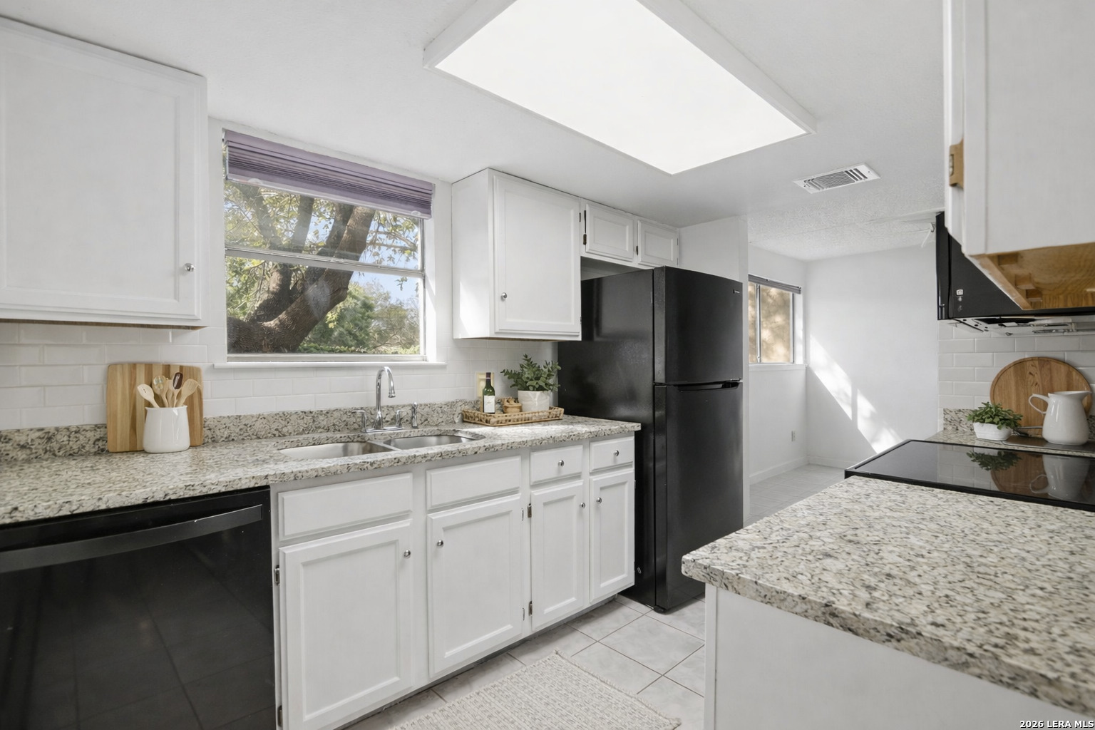8702 Stream Circle San Antonio, TX 78250 - Photo 3 of 18 a kitchen with a sink stove and refrigerator