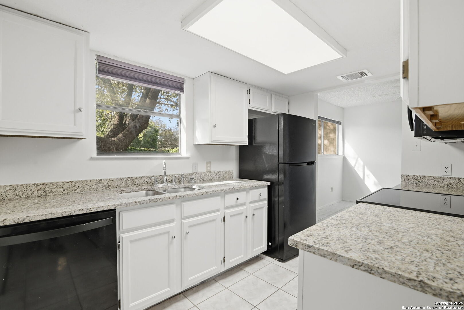 8702 Stream Circle San Antonio, TX 78250 - Photo 4 of 18 a kitchen with a sink stove and refrigerator