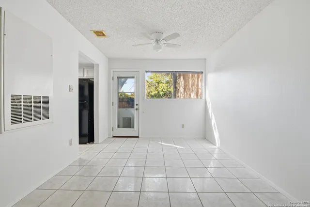 an empty room with windows and closet