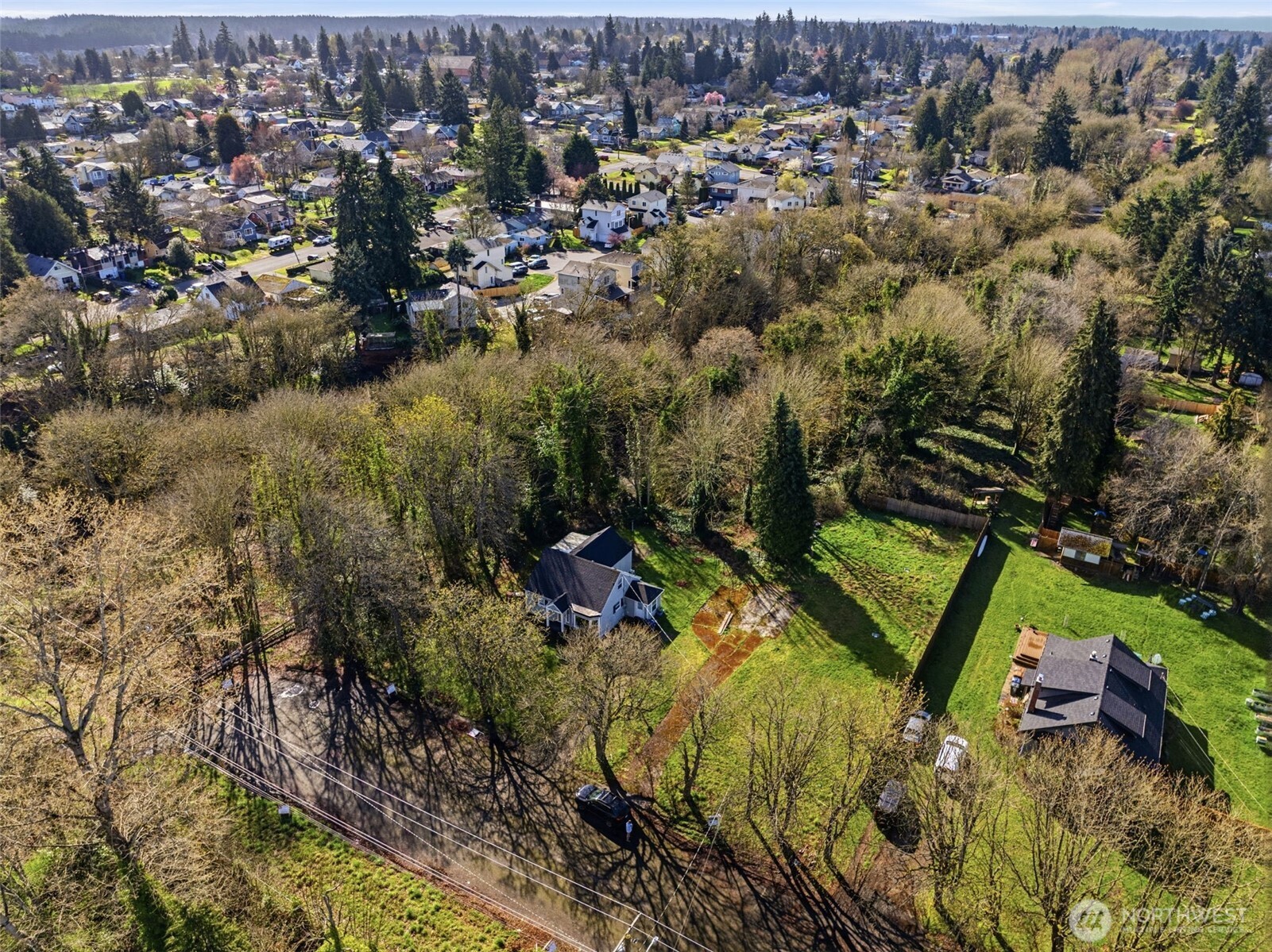 324 East 40th Street Tacoma, WA 98404 - Photo 7 of 17 an aerial view of residential houses with outdoor space and trees