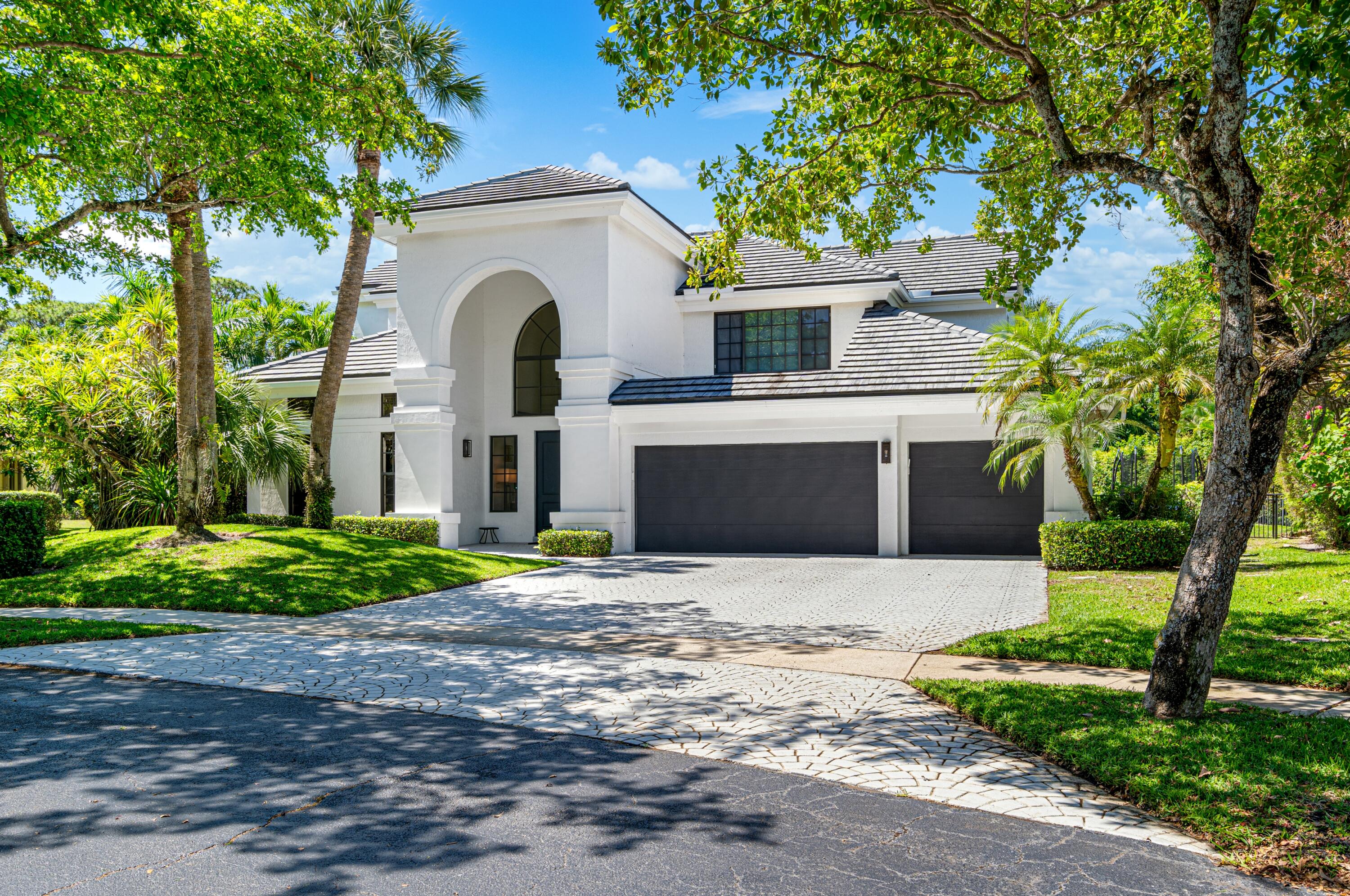 3098 Northwest 60th Street Boca Raton, FL 33496 - Photo 1 of 30 a front view of a house with garden