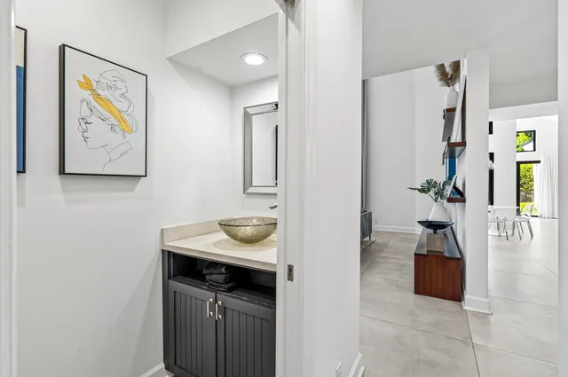 a view of staircase with railing and white walls