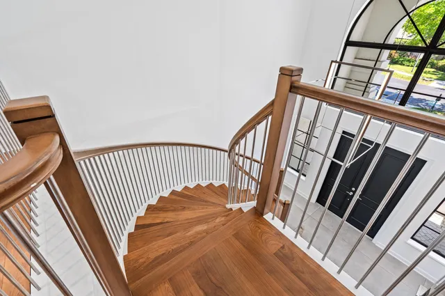 a living room with furniture flat screen tv and a large window