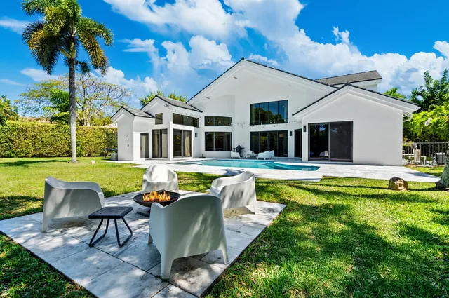 a front view of house with yard and green space