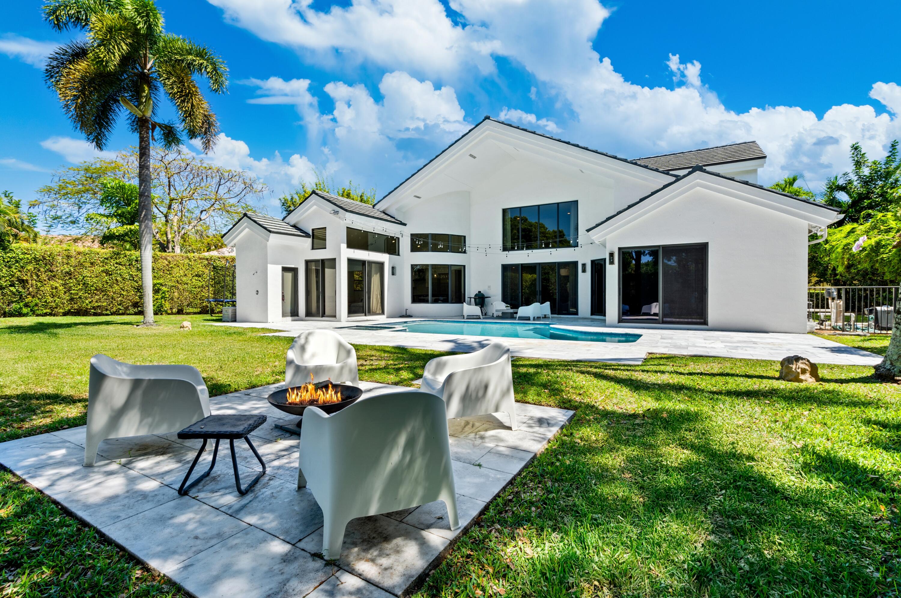 3098 Northwest 60th Street Boca Raton, FL 33496 - Photo 27 of 30 a view of a house with swimming pool and porch with furniture