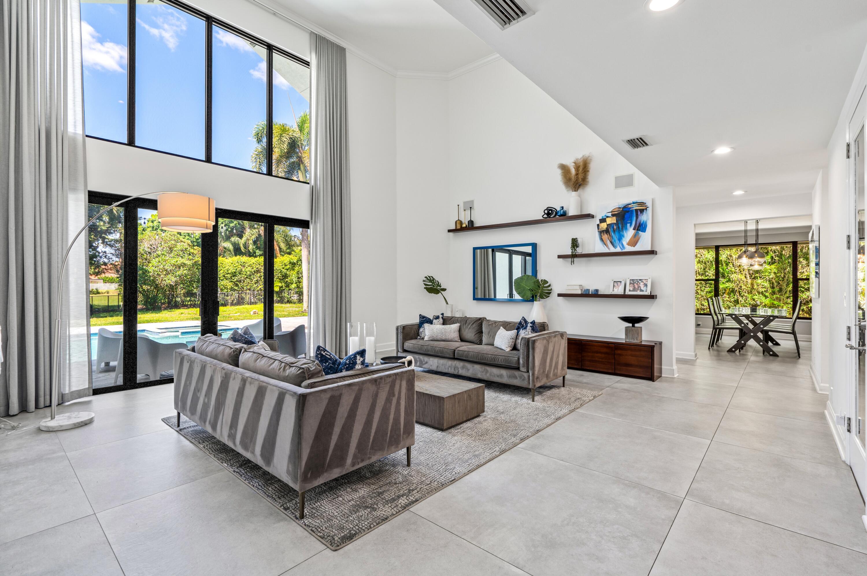 3098 Northwest 60th Street Boca Raton, FL 33496 - Photo 5 of 30 a living room with furniture and a large window