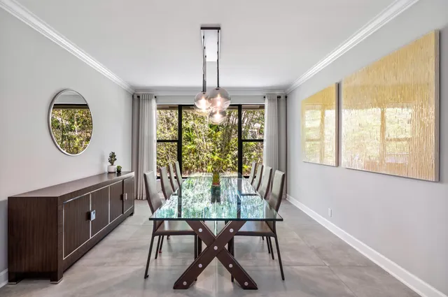 a kitchen with stainless steel appliances a kitchen island a table and chairs in it