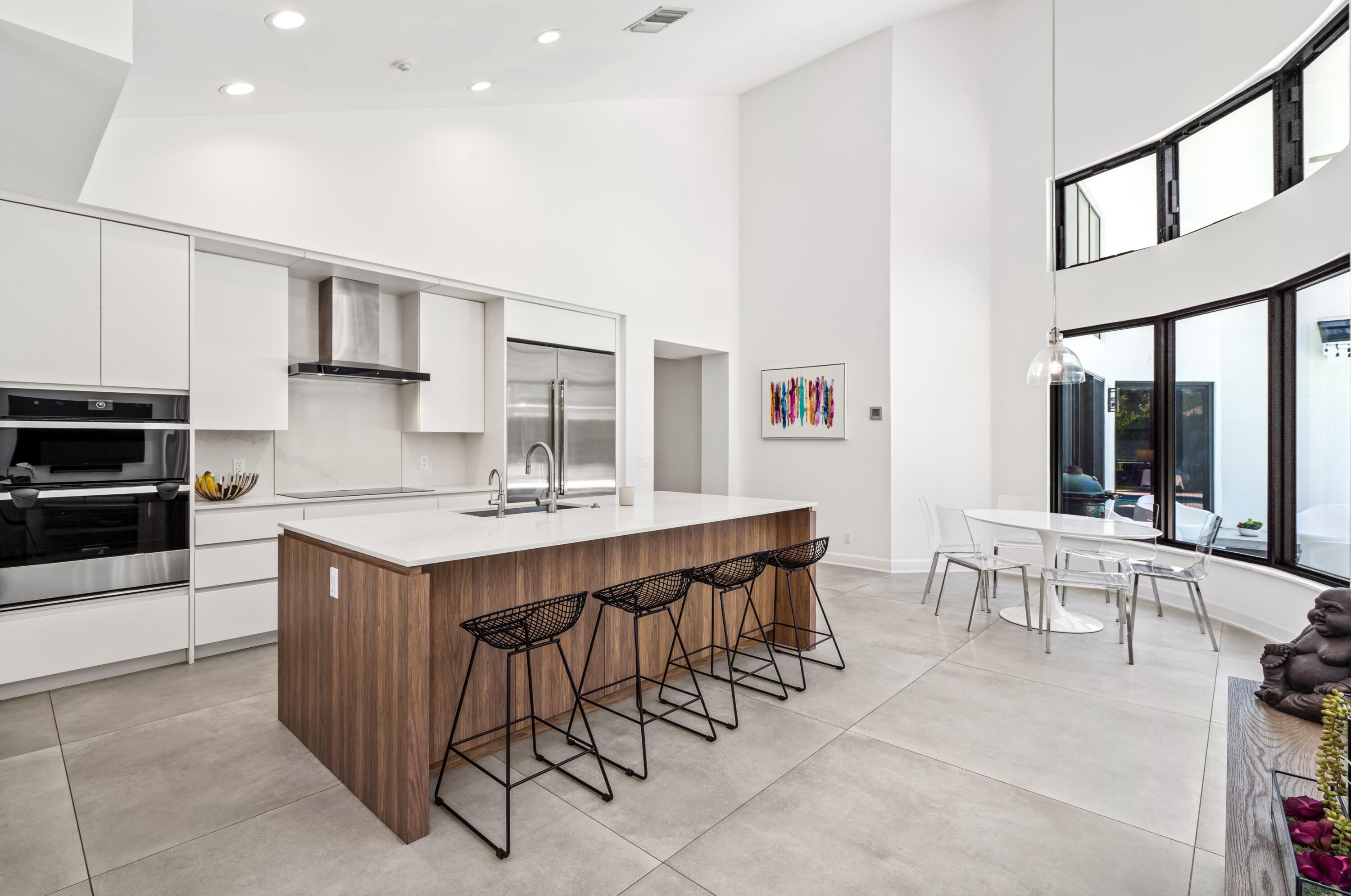 3098 Northwest 60th Street Boca Raton, FL 33496 - Photo 9 of 30 a kitchen with a sink and chairs