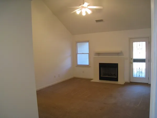 a view of empty room with a fireplace