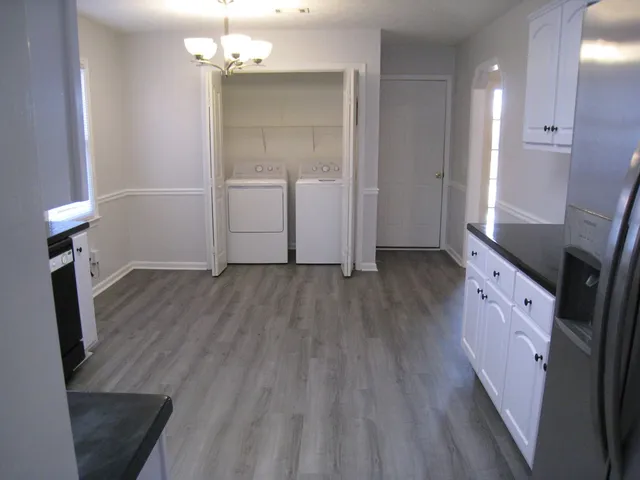 wooden floor in an empty room with a mirror