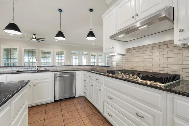 a kitchen with stainless steel appliances granite countertop a sink and oven