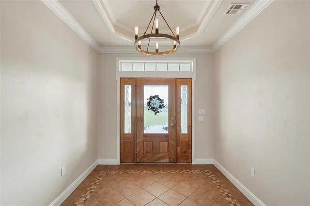 a view of an empty room with a fireplace and a window