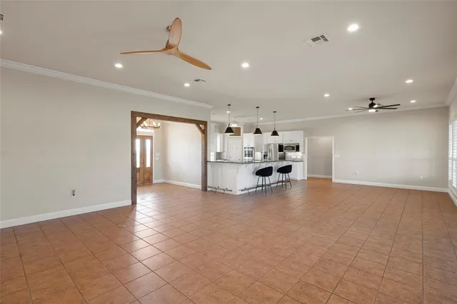 a living room with furniture and a view of kitchen
