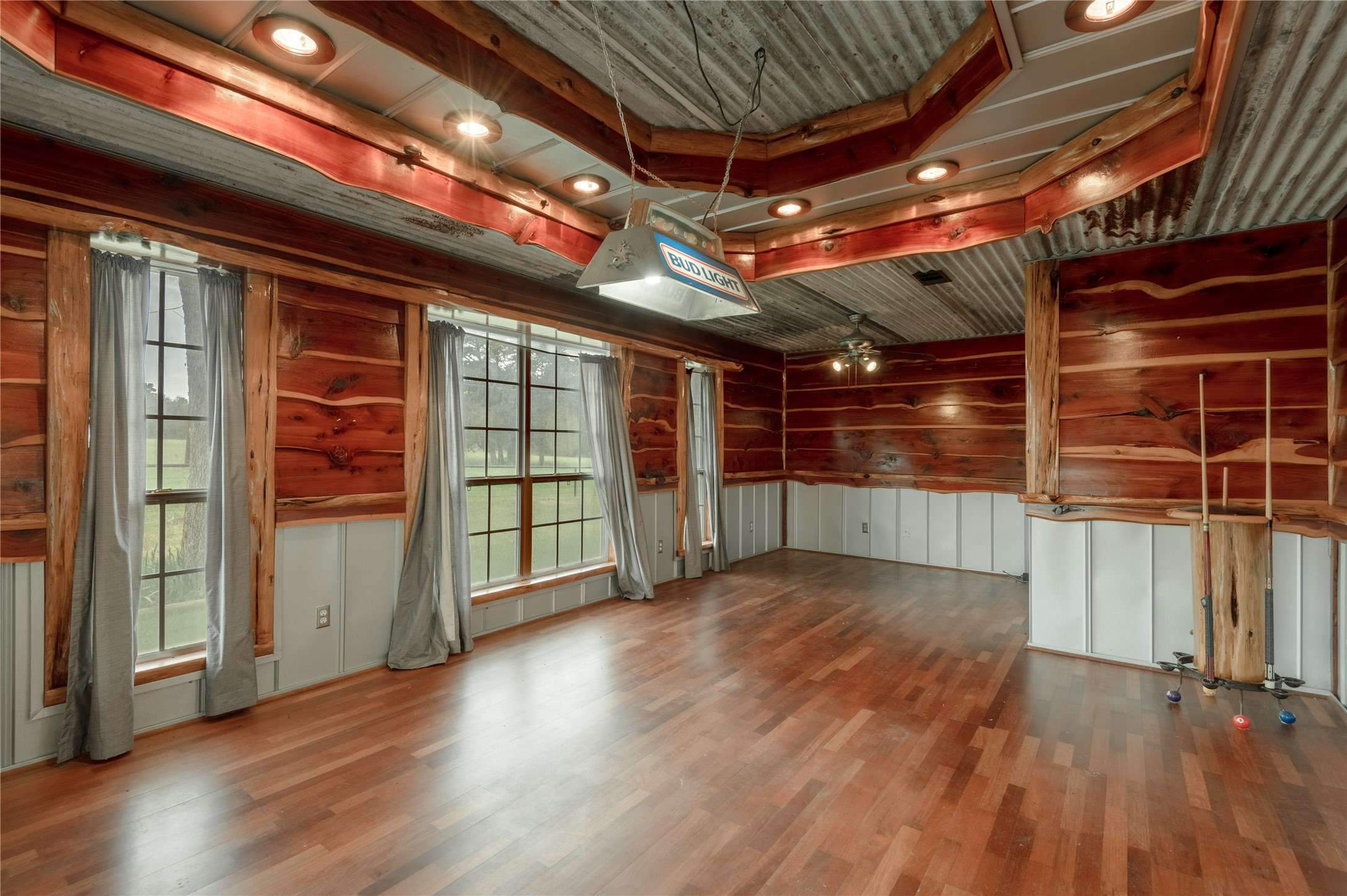 758 Wire Road Huntsville, TX 77320 - Photo 21 of 44 a view of an empty room with wooden floor and a window