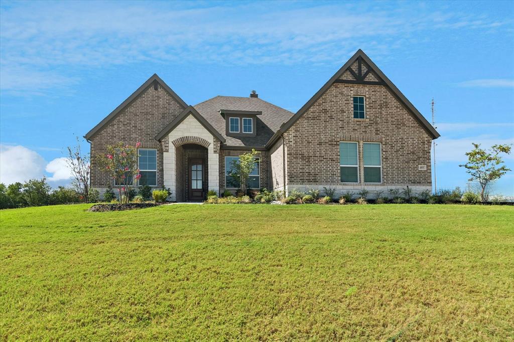401 Indian Creek Road Van Alstyne, TX 75495 - Photo 1 of 1 Brick exterior with stone accents, arched entry, and gabled rooflines