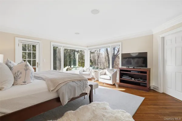 a bedroom with furniture and a flat screen tv