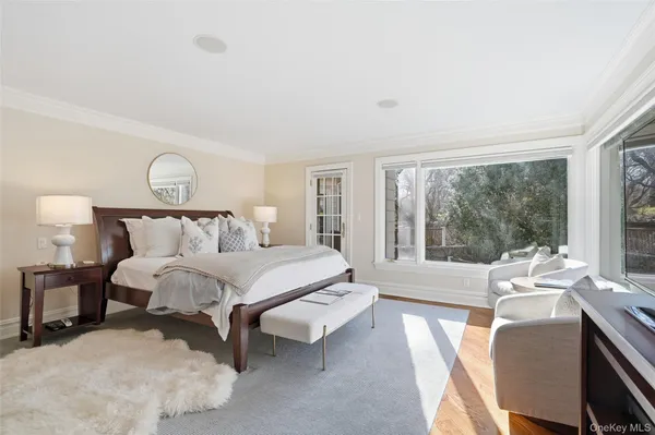 a bedroom with a bed and a large window