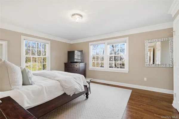 a bedroom with a large bed and a window