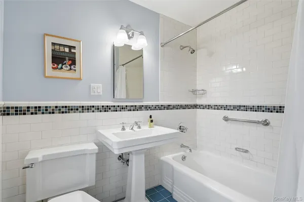 a white bath tub sitting next to a white sink