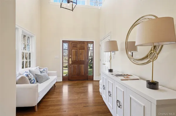 a spacious bedroom with a bed a mirror and a table