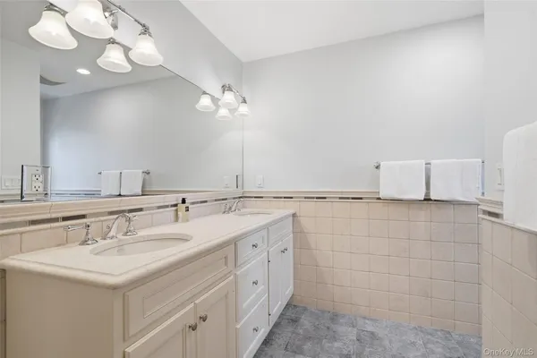 a bathroom with a sink a vanity and a mirror